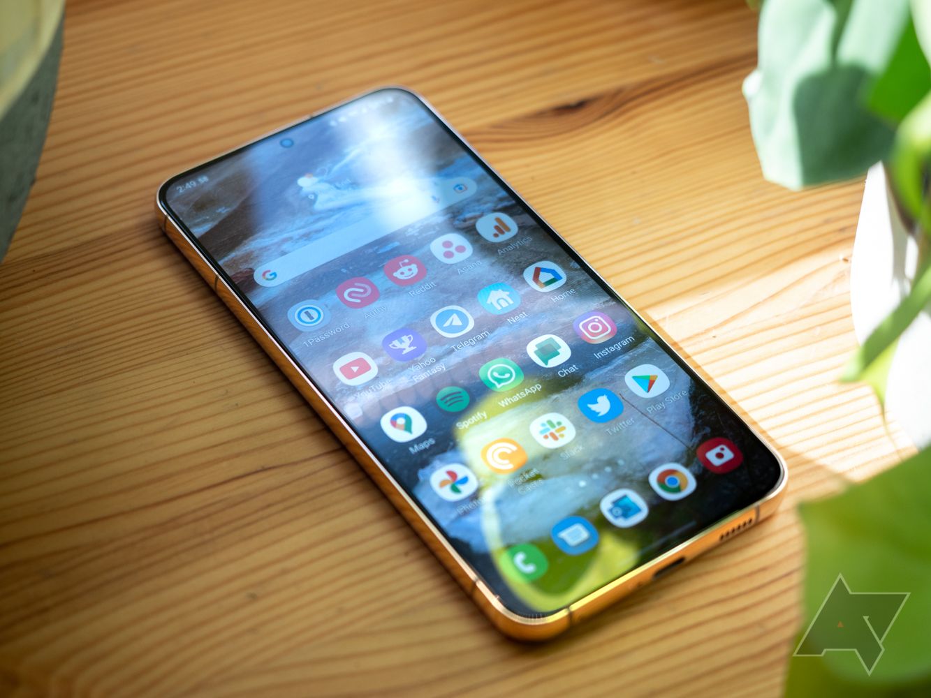 A Samsung Galaxy S22 Plus phone sitting on a wooden table