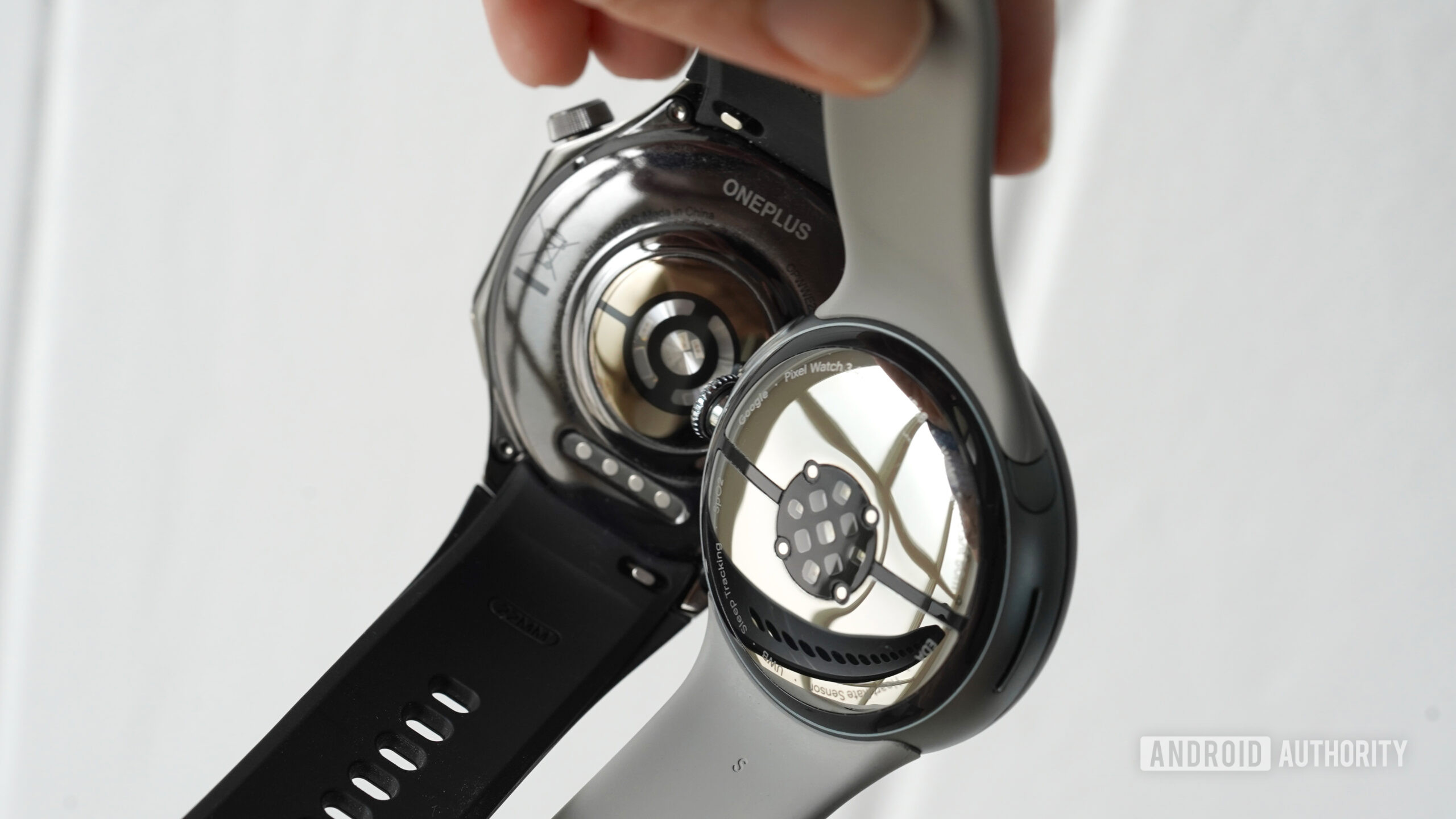 A users holds two Wear OS devices in hand, display the devices' sensors.