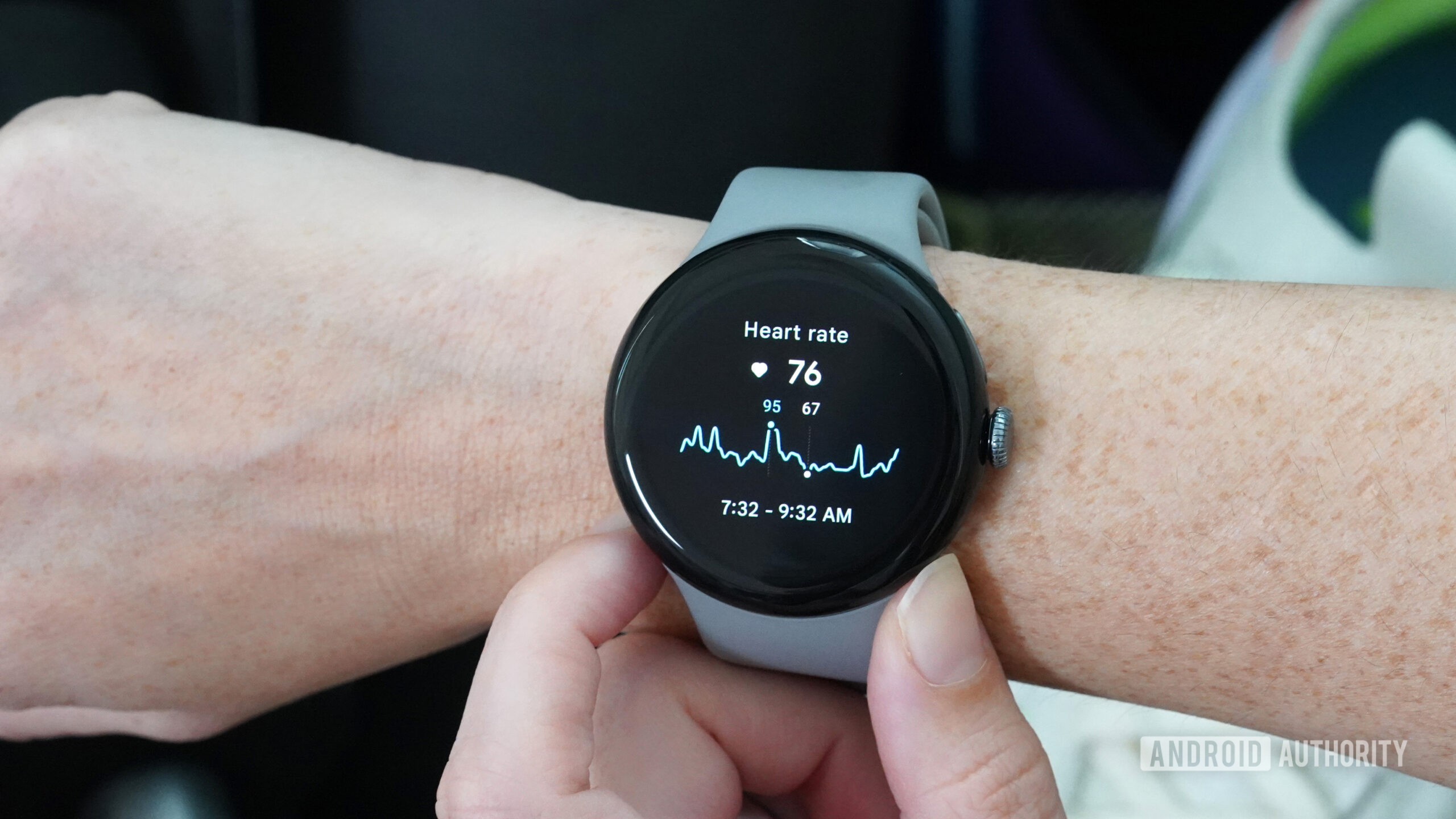 A Google Pixel Watch 3 on a user's wrists displays their heart rate data.