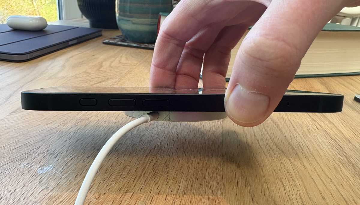 iPhone 16e connected to MagSafe charging puck