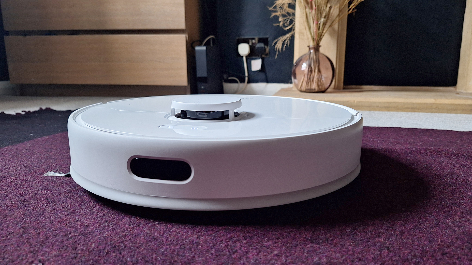 Dreame D9 Max Gen 2 robot vacuum in front of fireplace in reviewer's home