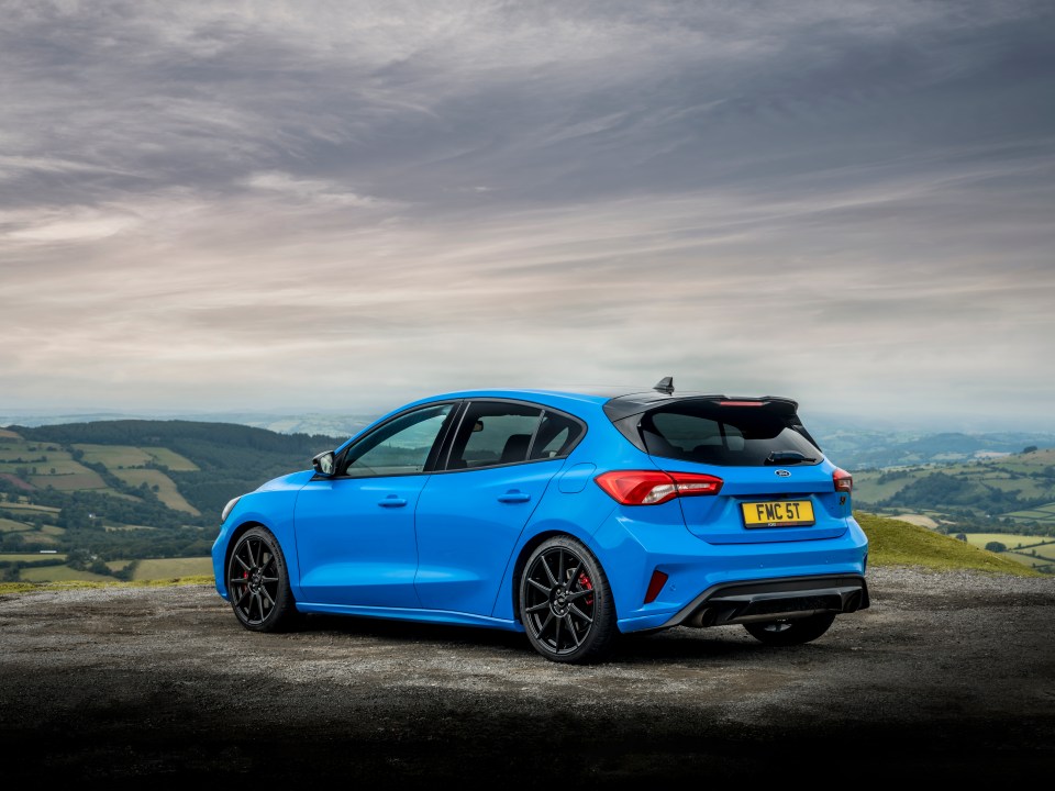 Blue Ford Focus ST Edition parked on a hilltop.