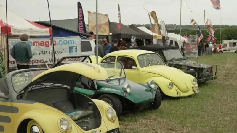 Several vintage Volkswagen Beetles and other classic cars on display at the Run To The Sun Festival.